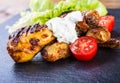 Grilling. Grilled chicken. Grilled chicken legs. Grilled chicken legs, lettuce and cherry tomatoes. Traditional cuisine. Royalty Free Stock Photo