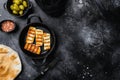 Grilling Halloumi Cheese, on black dark stone table background, top view flat lay, with copy space for text Royalty Free Stock Photo
