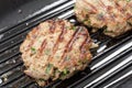 Grilling homemade beefburgers Royalty Free Stock Photo