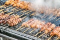 Grilling marinated meat on a charcoal grill