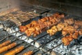 Grilling marinated shashlik on a grill. Shashlik is a form of Shish kebab Royalty Free Stock Photo