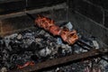 Grilling marinated shashlik on a grill.