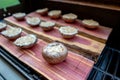 Grilling portobello mushrooms on cedar plank Royalty Free Stock Photo