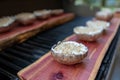 Grilling portobello mushrooms on cedar plank Royalty Free Stock Photo