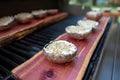 Grilling portobello mushrooms on cedar plank Royalty Free Stock Photo