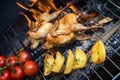 Grilling poultry quails and fresh juicy vegetables in a restaurant