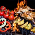 Grilling poultry quails and fresh juicy vegetables in a restaurant