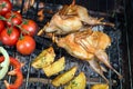 Grilling poultry quails and fresh juicy vegetables in a restaurant