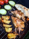 Grilling poultry quails and fresh juicy vegetables in a restaurant