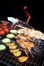 Grilling poultry quails and fresh juicy vegetables in a restaurant