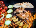 Grilling poultry quails and fresh juicy vegetables in a restaurant