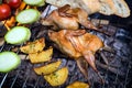 Grilling poultry quails and fresh juicy vegetables in a restaurant