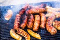 Grilling sausages on barbecue grill. Delicious sausages on charcoal grill