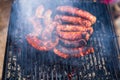 Grilling sausages on barbecue grill. Delicious sausages on charcoal grill