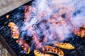 Grilling sausages on barbecue grill. Delicious sausages on charcoal grill