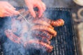 Grilling sausages on barbecue grill. Delicious sausages on charcoal grill