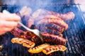 Grilling sausages on barbecue grill. Delicious sausages on charcoal grill