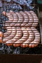 Grilling sausages in barbecue. Party time. Royalty Free Stock Photo