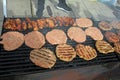 Grilling Sausages, Burgers, Pork Steak On Barbecues Gas Grill For Party. Hot Dogs,sausages And Hamburgers On A Barbeque, Bbq. Smok