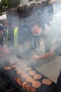 Grilling sausages, burgers, pork steak on barbecues gas grill for party. Hot dogs,sausages and hamburgers on a barbeque, bbq. Smok Royalty Free Stock Photo