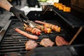 Grilling sausages and skewers on a barbecue Royalty Free Stock Photo