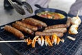 Grilling sausages and vegetables - outdoor cooking - summer BBQ Royalty Free Stock Photo