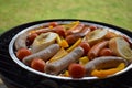 Grilling sausages and vegetables and spices on the grill Royalty Free Stock Photo