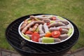 Grilling sausages and vegetables and spices on the grill Royalty Free Stock Photo