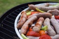 Grilling sausages and vegetables and spices on the grill Royalty Free Stock Photo