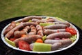 Grilling sausages and vegetables and spices on the grill Royalty Free Stock Photo