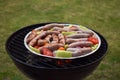 Grilling sausages and vegetables and spices on the grill Royalty Free Stock Photo