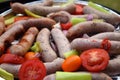 Grilling sausages and vegetables and spices on the grill Royalty Free Stock Photo