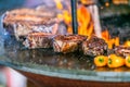 Grilling steaks on flaming grill