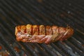 Grilling steaks on flaming grill .