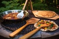 grilling tools and pizza peel near barbecue