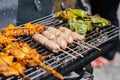 Grilling various meats on short, thin bamboo skewers over an open fire or grill.
