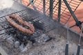 Grilling wursts on barbecue grill. Grilled meat sausages