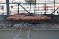 Grilling wursts on barbecue grill. Grilled meat sausages