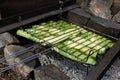 Grilling zucchini on barbecue grill with fire flames and smoke. Selective focus. Summer food. Ideas for barbecue, grill party Royalty Free Stock Photo