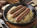 Grillmaster's Choice: Roasted Bratwurst and Sauerkraut Delight Royalty Free Stock Photo