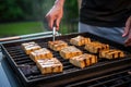 grillmaster uncovering sizzling tofu steaks on a grill Royalty Free Stock Photo