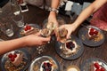 Grils party. Grils cheers glasses with champagne in restraunt. Dessert cakes background