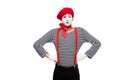 grimacing mime standing with hands akimbo