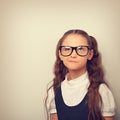 Grimacing pupil girl with long hair style in fashion eyeglasses