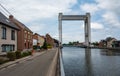 Grimbergen, Flemish Brabant, Belgium - Suspension bridge and residential houses at the banks of the canal