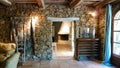 View into room of french cottage built of natural materials in style prevencale with natural stone wall and wood ceiling