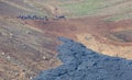 A unique natural attraction. People are walking over the new lavafield of the volcano eruption Royalty Free Stock Photo