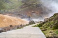 Tourists visit the Seltun Geothermal Area, watching steam from a dangerous hot spring