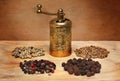 Grinder and spices on a wooden board