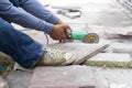 Grinder worker cuts a stone tile Royalty Free Stock Photo